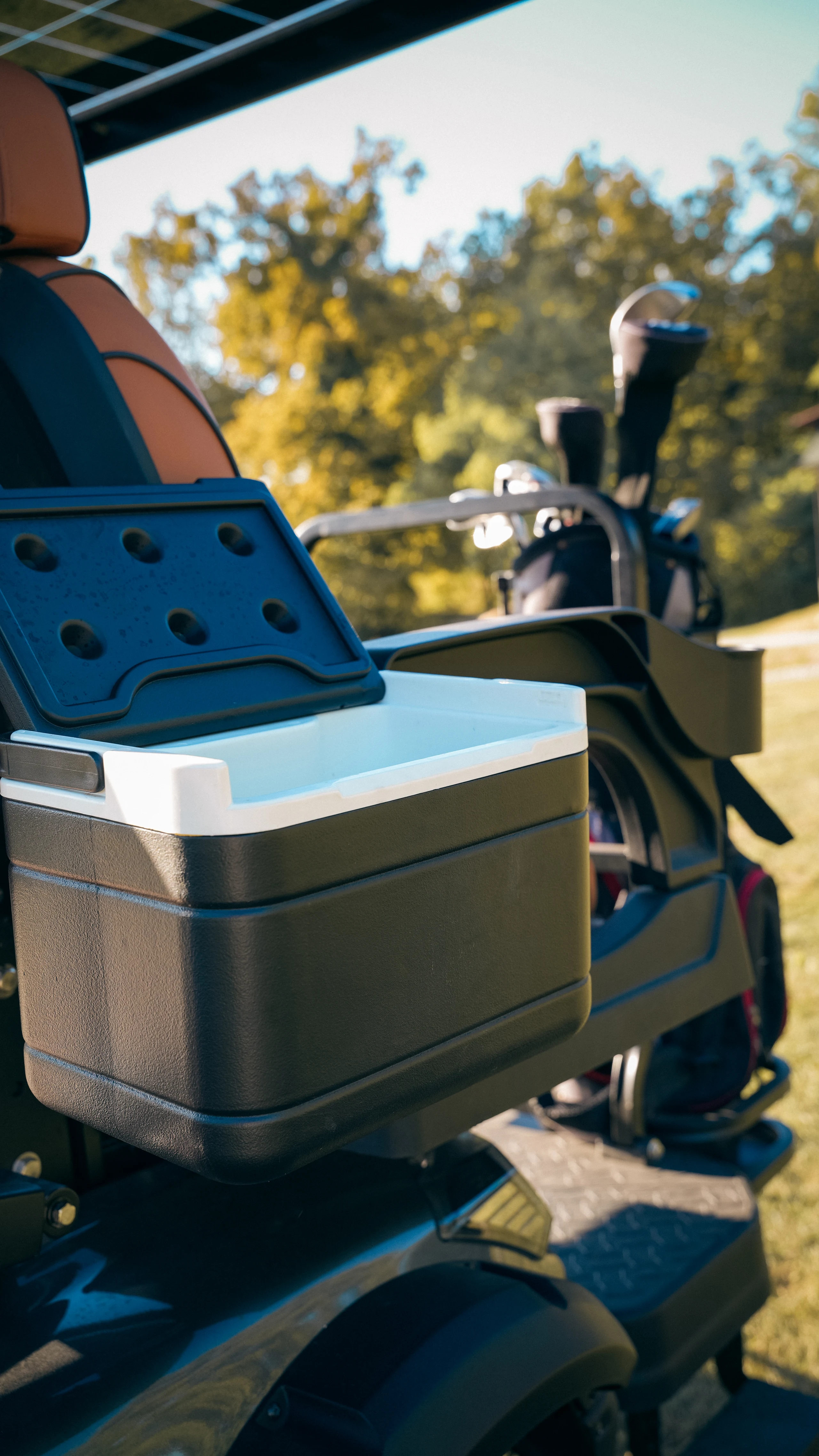 Cooler beside the golf equipment