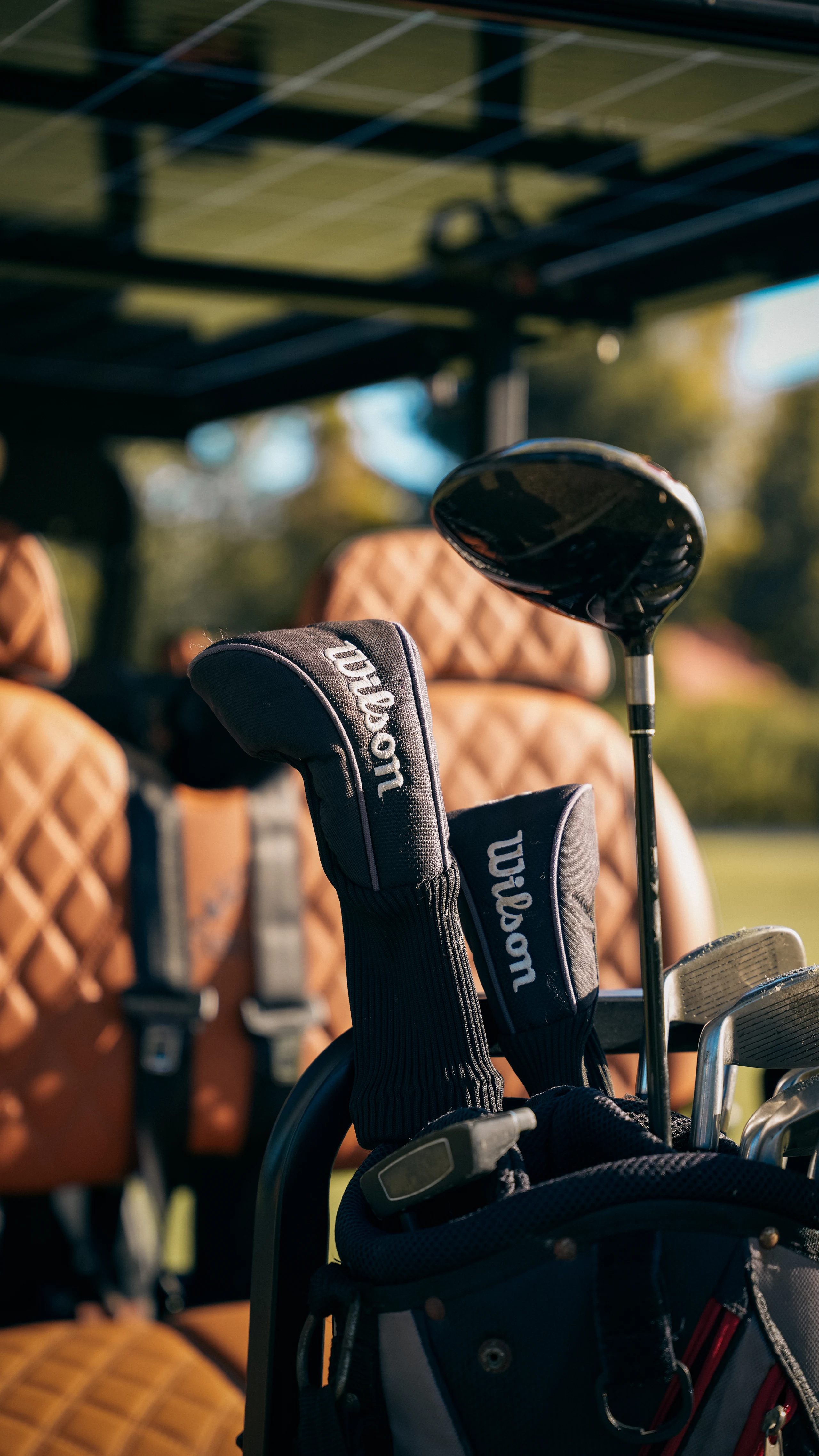 Golf equipment beside the seats