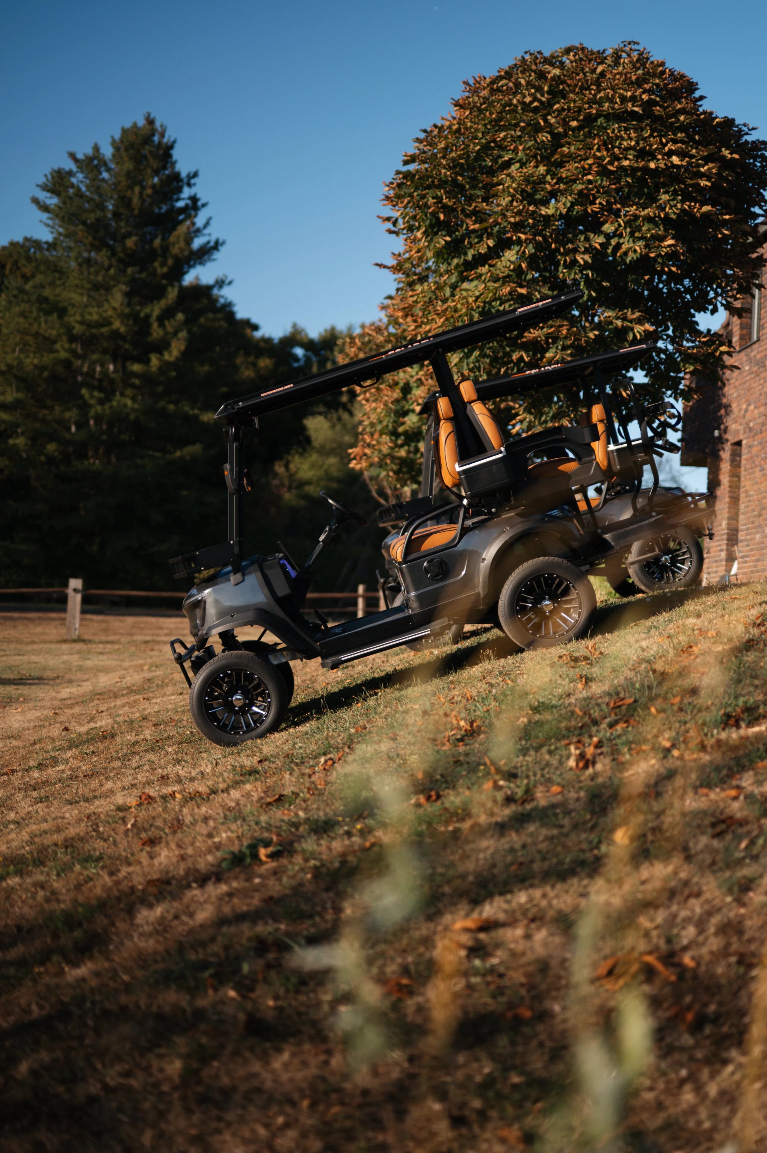 Golf Shuttle Elite 2 + 2 — by the stone building